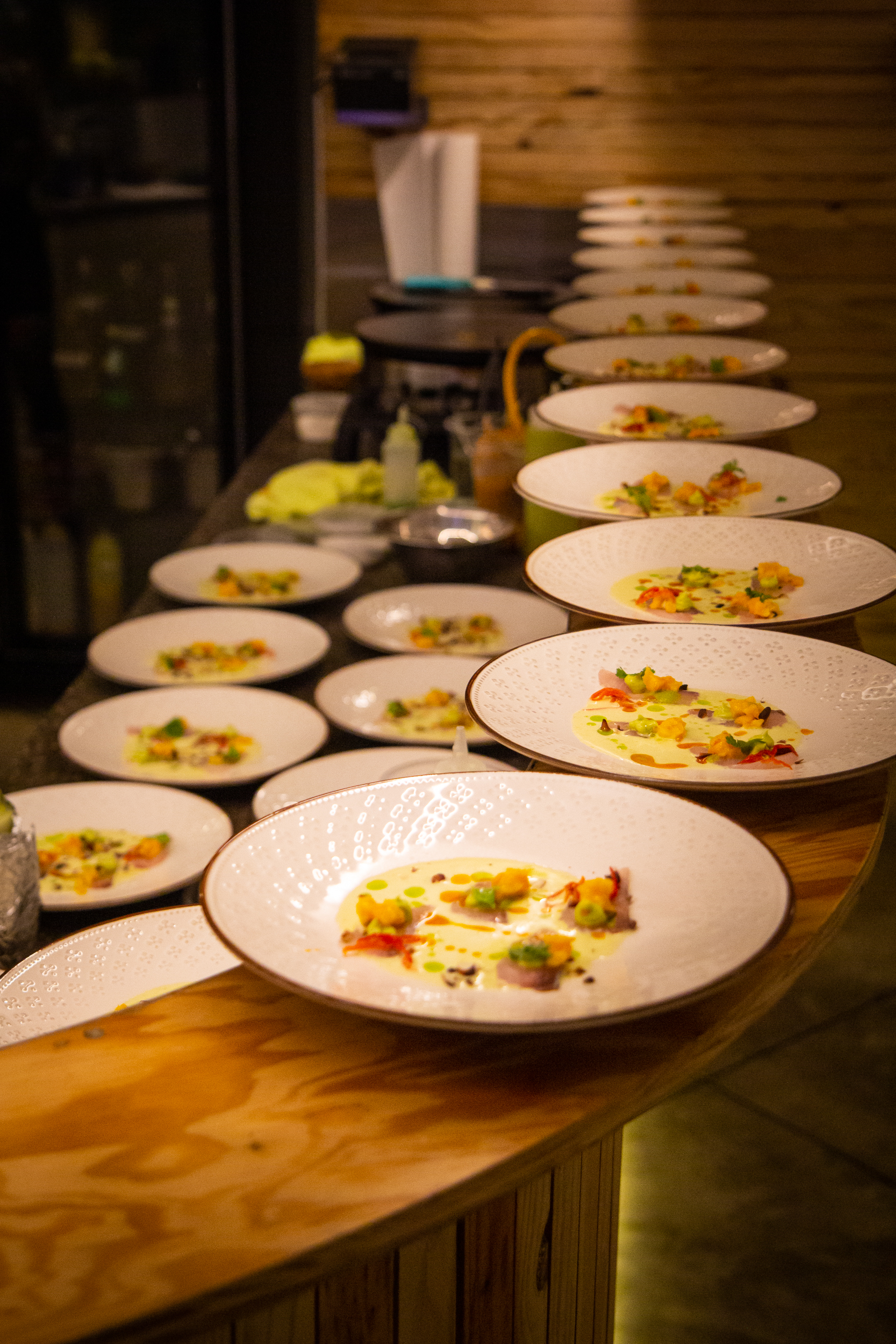 Plated dishes lined up on a counter before service