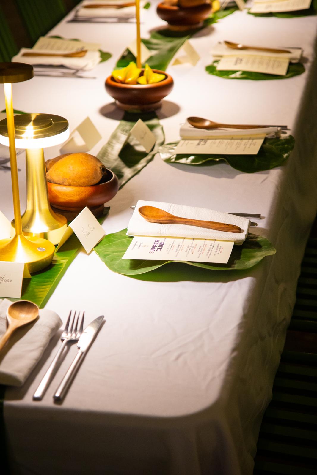 Table set with menus, leaf-shaped placemats and small lamps